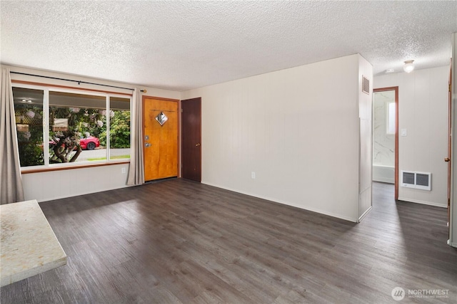 16327 Smokey Point Blvd Unit 1 & 2, Marysville, WA 98271 - unfurnished living room featuring dark wood finished floors, a textured ceiling, and baseboards