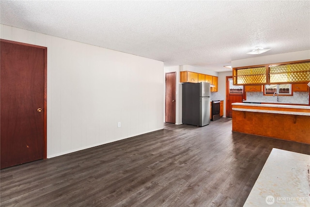 16327 Smokey Point Blvd Unit 1 & 2, Marysville, WA 98271 - kitchen with stainless steel appliances, light countertops, dark wood-type flooring, a sink, and a textured ceiling