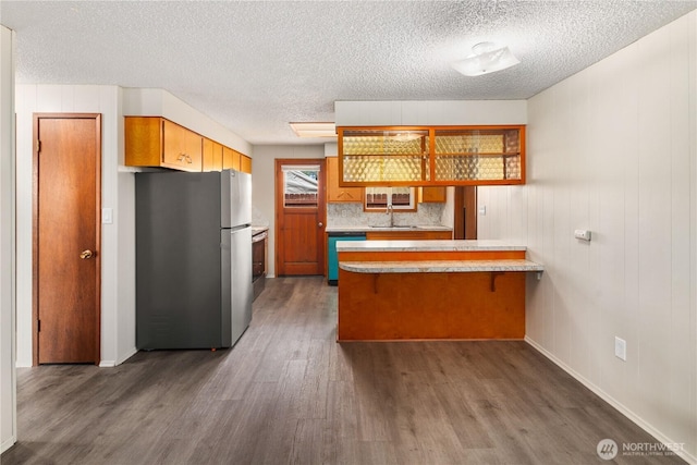 16327 Smokey Point Blvd Unit 1 & 2, Marysville, WA 98271 - kitchen featuring freestanding refrigerator, a peninsula, a sink, dark wood finished floors, and light countertops