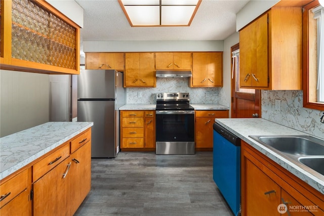 16327 Smokey Point Blvd Unit 1 & 2, Marysville, WA 98271 - kitchen featuring stainless steel appliances, under cabinet range hood, brown cabinetry, and light countertops