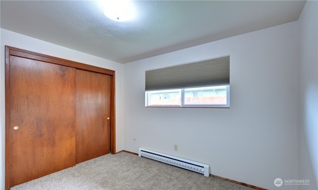 16327 Smokey Point Blvd Unit 1 & 2, Marysville, WA 98271 - unfurnished bedroom featuring a baseboard heating unit, carpet, a closet, and baseboards