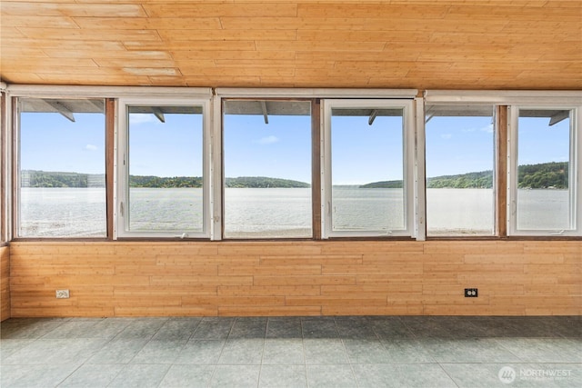 24186 Vashon Hwy SW, Vashon, WA 98070 - unfurnished sunroom featuring healthy amount of natural light, wooden ceiling, wooden walls, and a water view