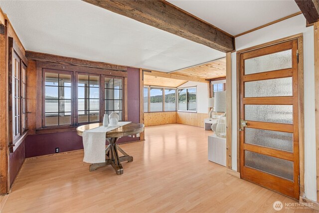 24186 Vashon Hwy SW, Vashon, WA 98070 - dining area featuring wood walls, wood finished floors, a water view, and beamed ceiling