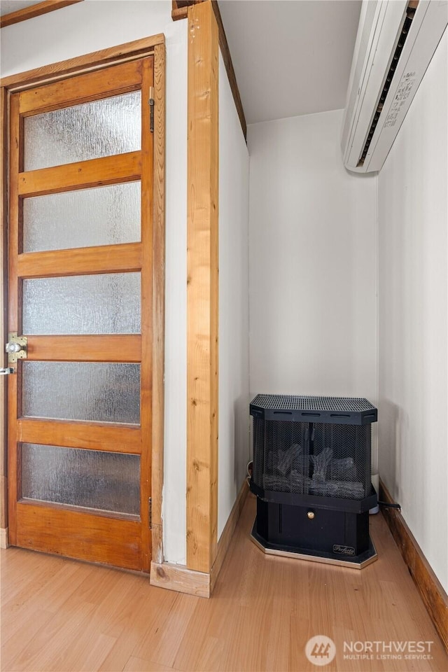 24186 Vashon Hwy SW, Vashon, WA 98070 - walk in closet with a wood stove, a wall mounted AC, and wood finished floors
