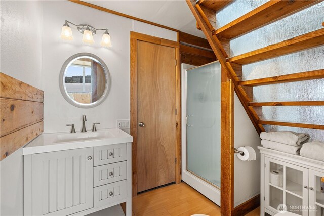 24186 Vashon Hwy SW, Vashon, WA 98070 - full bathroom with a stall shower, vanity, and wood finished floors