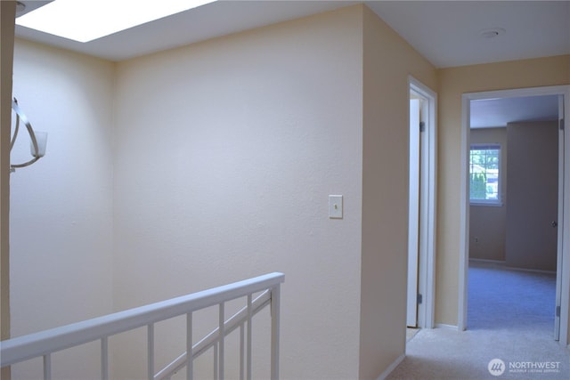 2113 186th Pl SE, Bothell, WA 98012 - hall with light colored carpet, an upstairs landing, a skylight, and baseboards