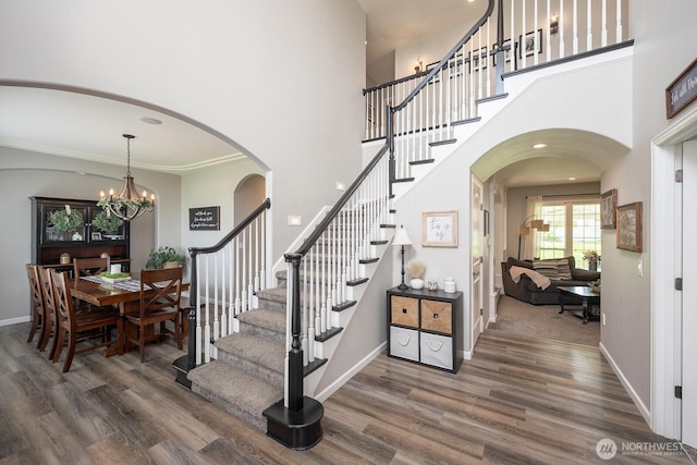331 Viewmont Dr SE, Moses Lake, WA 98837 - stairway with wood finished floors, baseboards, a towering ceiling, and arched walkways