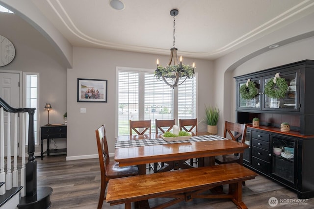 331 Viewmont Dr SE, Moses Lake, WA 98837 - dining area featuring arched walkways, a chandelier, wood finished floors, stairs, and baseboards