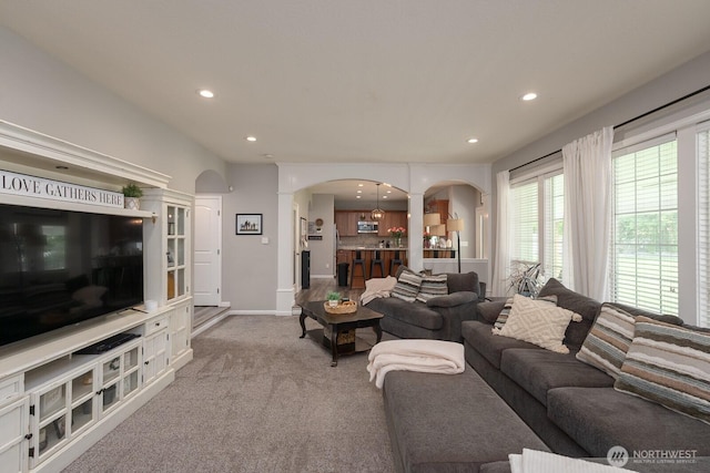 331 Viewmont Dr SE, Moses Lake, WA 98837 - living room featuring arched walkways, ornate columns, light carpet, recessed lighting, and baseboards