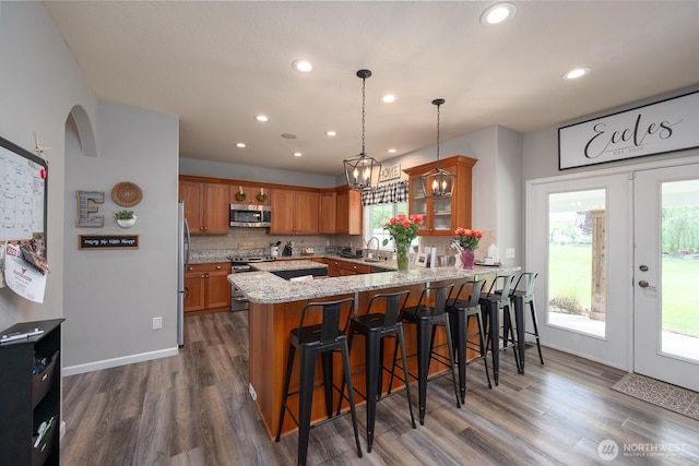 331 Viewmont Dr SE, Moses Lake, WA 98837 - kitchen with appliances with stainless steel finishes, a peninsula, recessed lighting, brown cabinetry, and dark wood finished floors