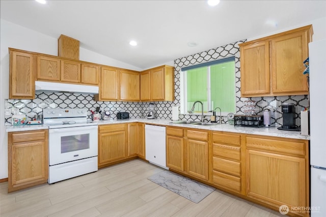 1701 E Burr Ave Unit 36, Moses Lake, WA 98837 - kitchen with white appliances, under cabinet range hood, vaulted ceiling, light countertops, and tasteful backsplash
