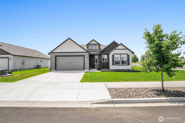 4737 W Owl St, Moses Lake, WA 98837 - view of front of home with an attached garage, concrete driveway, a front yard, and cooling unit