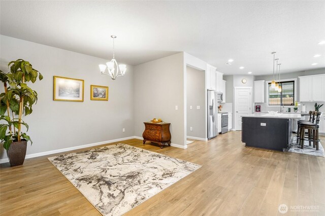 4737 W Owl St, Moses Lake, WA 98837 - living area featuring light wood-type flooring, a chandelier, baseboards, and recessed lighting