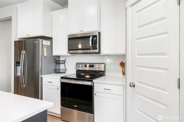 4737 W Owl St, Moses Lake, WA 98837 - kitchen with appliances with stainless steel finishes, light countertops, decorative backsplash, and white cabinetry