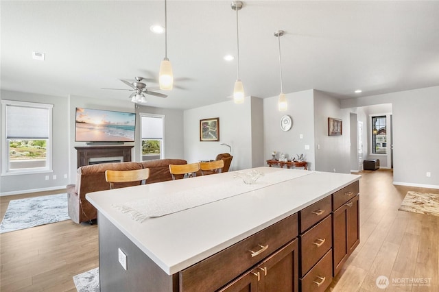4737 W Owl St, Moses Lake, WA 98837 - kitchen featuring open floor plan, light wood-style floors, light countertops, decorative light fixtures, and recessed lighting