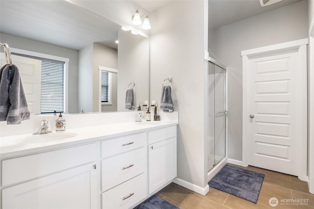 4737 W Owl St, Moses Lake, WA 98837 - full bathroom with double vanity, a stall shower, and baseboards