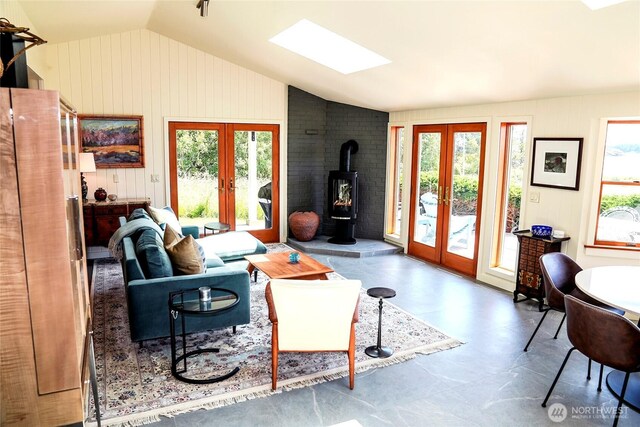 62 Wildwood Ln, Lopez Island, WA 98261 - living room with french doors, vaulted ceiling, plenty of natural light, a skylight, and a wood stove