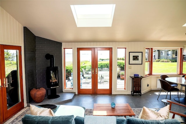 62 Wildwood Ln, Lopez Island, WA 98261 - living room with a skylight, french doors, a wood stove, and vaulted ceiling