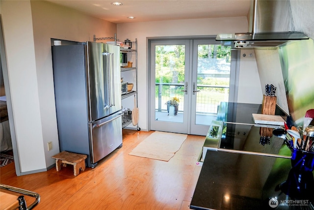 62 Wildwood Ln, Lopez Island, WA 98261 - kitchen featuring high end refrigerator, island range hood, french doors, light wood-style floors, and recessed lighting