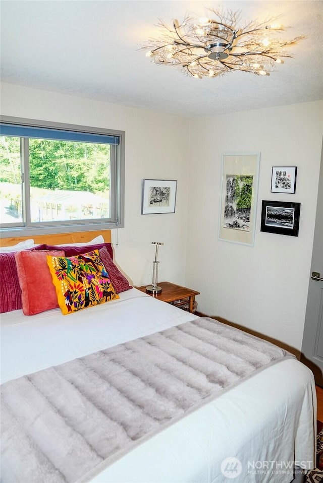 62 Wildwood Ln, Lopez Island, WA 98261 - bedroom with multiple windows and a chandelier