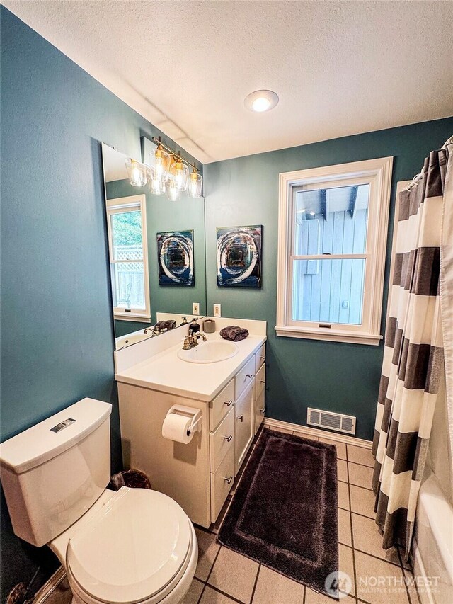 62 Wildwood Ln, Lopez Island, WA 98261 - full bathroom featuring a textured ceiling, vanity, tile patterned flooring, and shower / bath combo with shower curtain