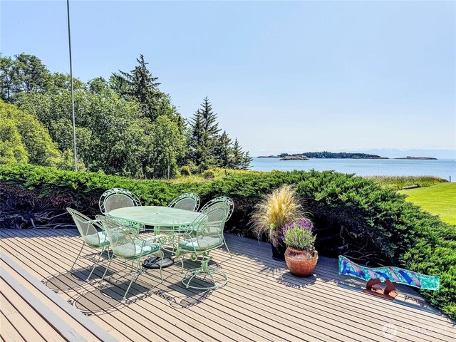 62 Wildwood Ln, Lopez Island, WA 98261 - wooden deck featuring outdoor dining space and a water view