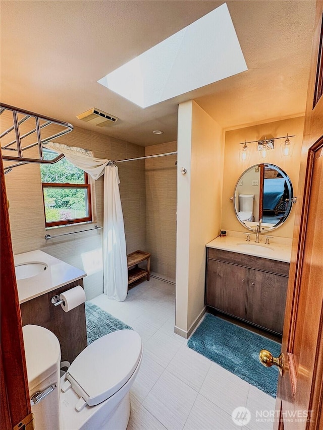 62 Wildwood Ln, Lopez Island, WA 98261 - bathroom featuring a skylight, vanity, tiled shower, and tile patterned floors