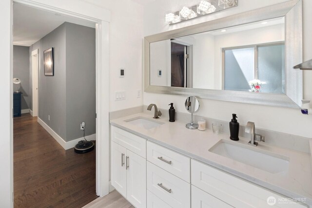 16422 76th Ave NE, Kenmore, WA 98028 - full bath featuring double vanity, wood finished floors, and baseboards