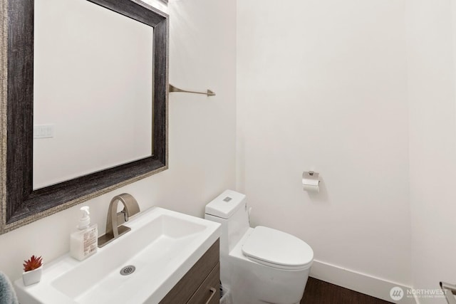 16422 76th Ave NE, Kenmore, WA 98028 - half bath with vanity, toilet, baseboards, and wood finished floors