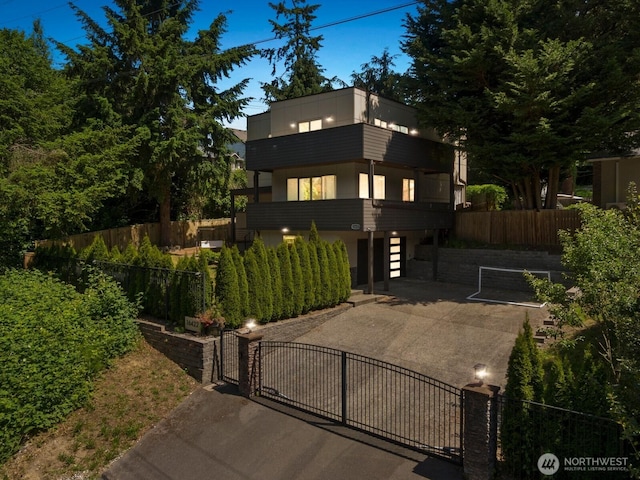 16422 76th Ave NE, Kenmore, WA 98028 - contemporary house with a gate, a patio area, and driveway