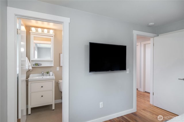 1079 Center St, Port Townsend, WA 98368 - bedroom featuring a sink, light wood finished floors, and baseboards
