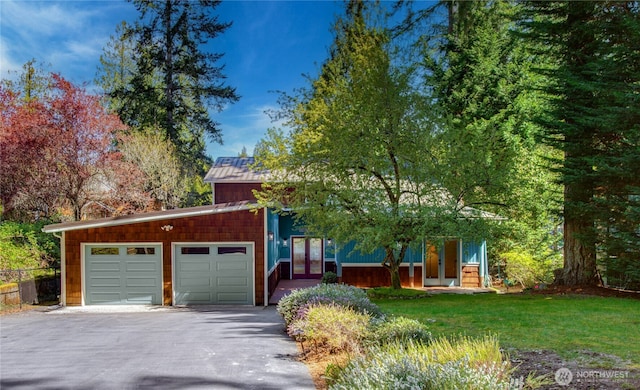 2942 222nd Pl SE, Sammamish, WA 98075 - view of front of home with an attached garage, asphalt driveway, a front yard, and french doors