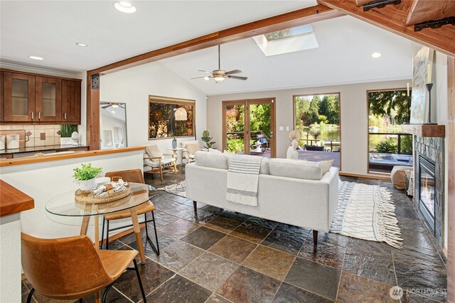 2942 222nd Pl SE, Sammamish, WA 98075 - living area featuring stone tile floors, a ceiling fan, recessed lighting, a large fireplace, and a skylight