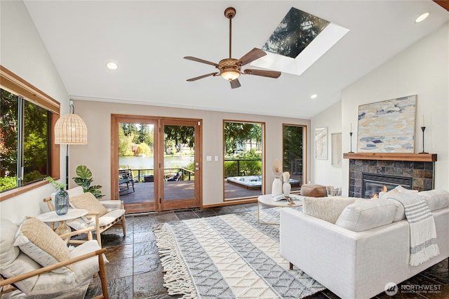 2942 222nd Pl SE, Sammamish, WA 98075 - living area featuring plenty of natural light, stone tile flooring, a ceiling fan, a tiled fireplace, and recessed lighting