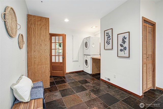 2942 222nd Pl SE, Sammamish, WA 98075 - foyer featuring stacked washer / dryer, baseboards, dark stone finish flooring, and recessed lighting