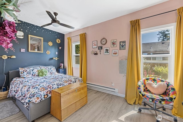 2702 16th St, Everett, WA 98201 - bedroom featuring a baseboard heating unit, light wood-style floors, a ceiling fan, and baseboards