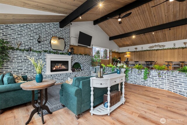 18501 52nd Ave W Unit 83, Lynnwood, WA 98037 - living room with wood finished floors, ceiling fan, a glass covered fireplace, brick wall, and high vaulted ceiling