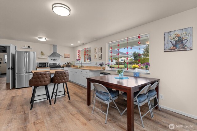 18501 52nd Ave W Unit 83, Lynnwood, WA 98037 - dining room with light wood finished floors, recessed lighting, and baseboards