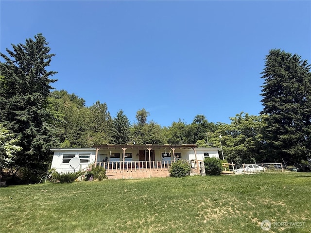24 Hubbert Rd, Omak, WA 98841 - rear view of property featuring a lawn and a wooded view