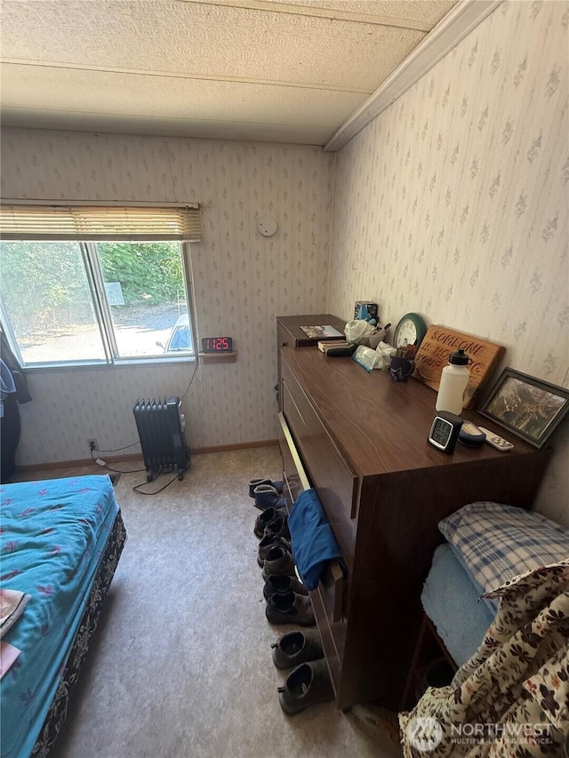 24 Hubbert Rd, Omak, WA 98841 - carpeted bedroom with wallpapered walls and radiator heating unit