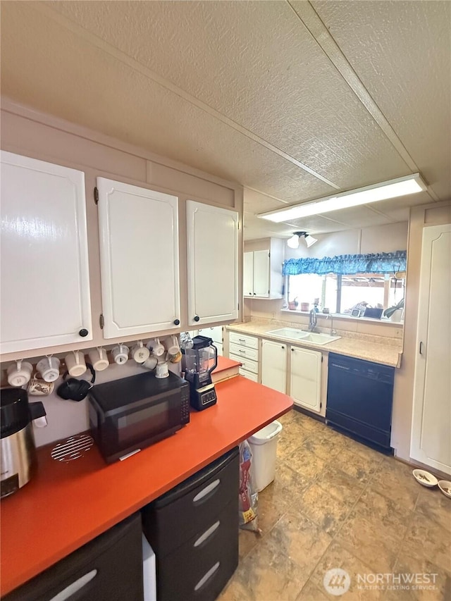 24 Hubbert Rd, Omak, WA 98841 - kitchen featuring black dishwasher, a sink, white cabinets, light countertops, and a textured ceiling