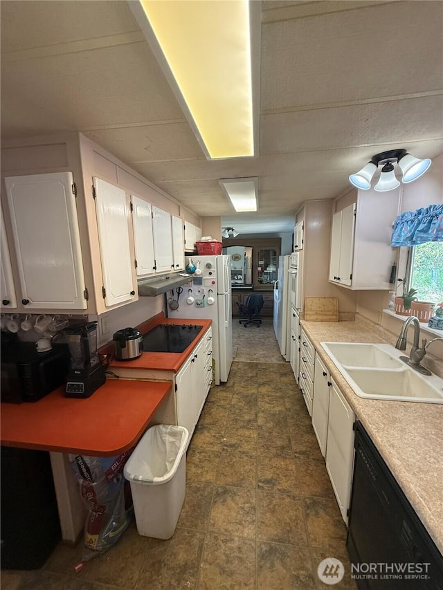 24 Hubbert Rd, Omak, WA 98841 - kitchen featuring a sink, black appliances, white cabinetry, stone finish floors, and light countertops