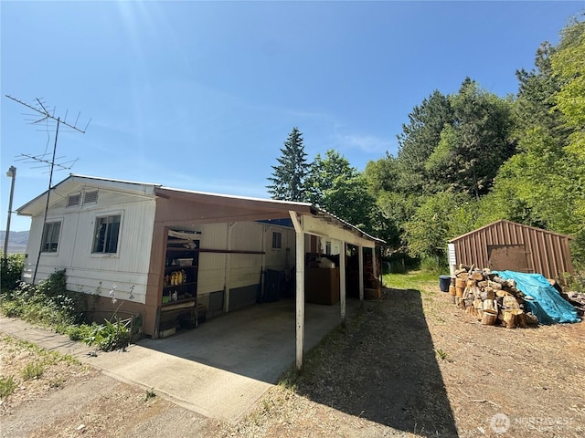 24 Hubbert Rd, Omak, WA 98841 - view of home's exterior featuring driveway and a carport