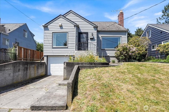6712 A St, Tacoma, WA 98408 - view of front of house featuring an attached garage, driveway, and a chimney