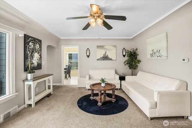 6712 A St, Tacoma, WA 98408 - living area with carpet, ceiling fan, crown molding, arched walkways, and baseboards
