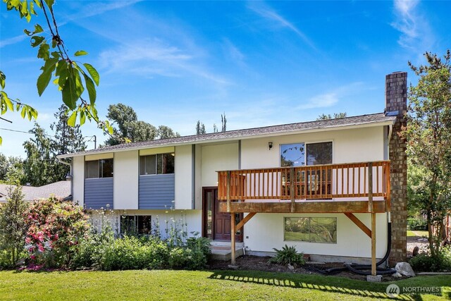 3125 Mcleod Rd, Bellingham, WA 98225 - view of front of home with a front lawn, a chimney, stucco siding, and a deck