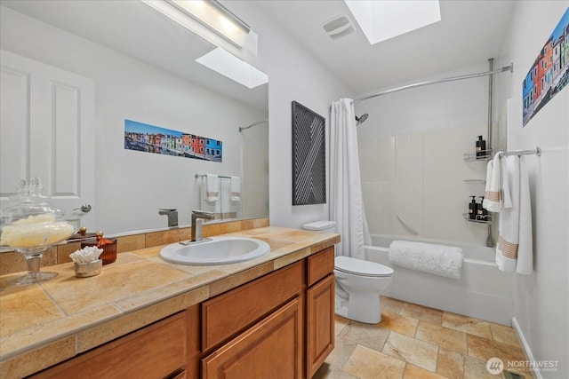 7320 111th Pl SE, Newcastle, WA 98056 - full bathroom featuring a skylight, shower / bath combination with curtain, vanity, and stone finish floors