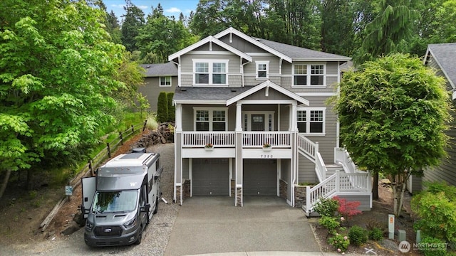7320 111th Pl SE, Newcastle, WA 98056 - view of front of home with board and batten siding, a garage, driveway, a porch, and stairs