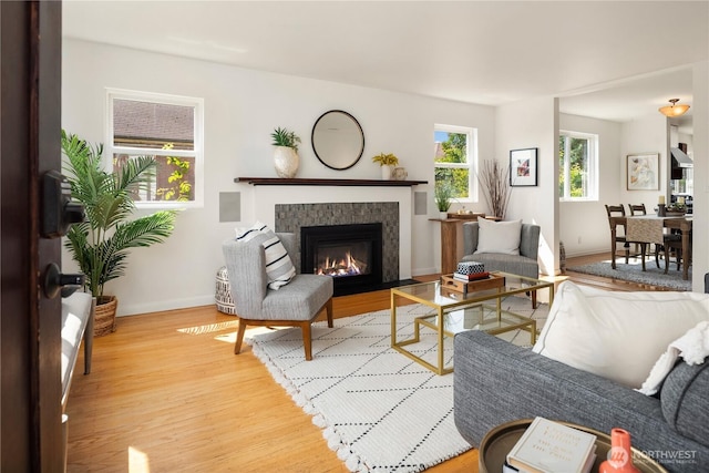 1210 S Mcclellan St, Seattle, WA 98144 - living area featuring light wood finished floors, baseboards, and a tile fireplace