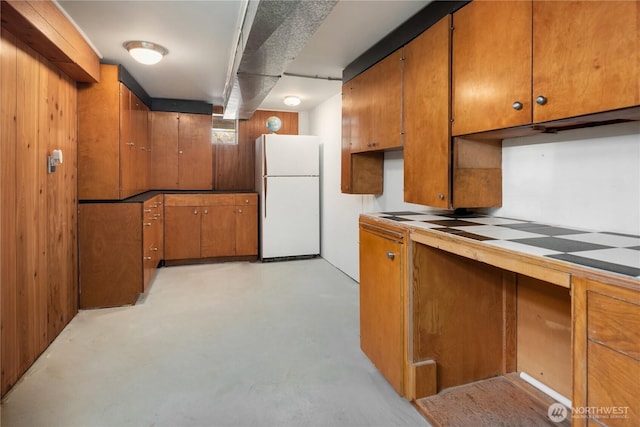 1210 S Mcclellan St, Seattle, WA 98144 - kitchen featuring freestanding refrigerator, brown cabinetry, and finished concrete flooring